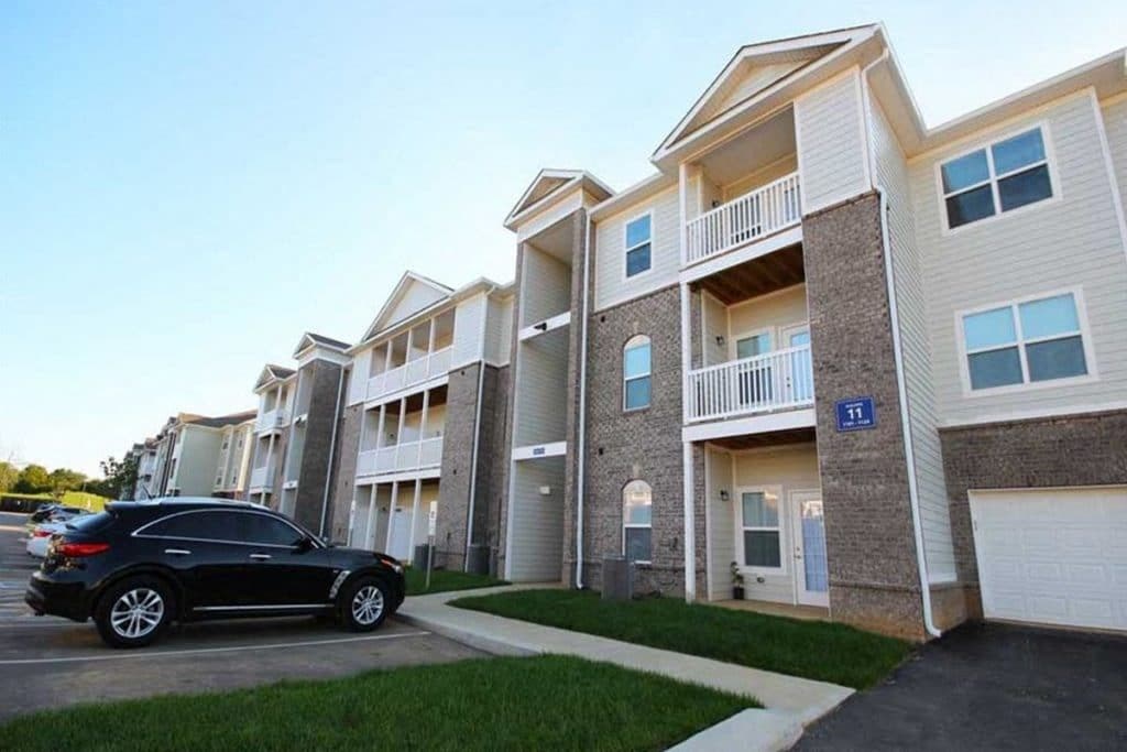 a car parked in front of an apartment building