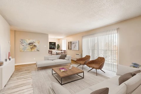 A living room with a white couch, a brown chair, and a coffee table.