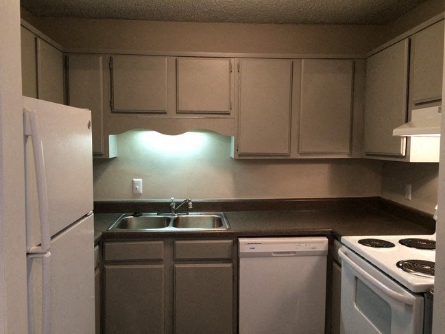 a kitchen with white appliances and a white stove top oven