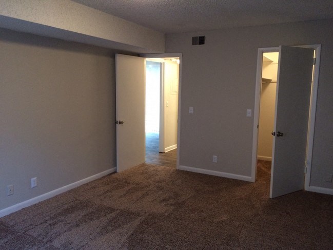 an empty room with two open doors