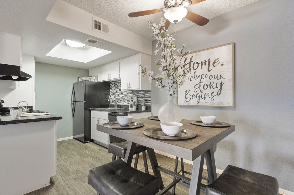 an open kitchen and dining area with a table and chairs