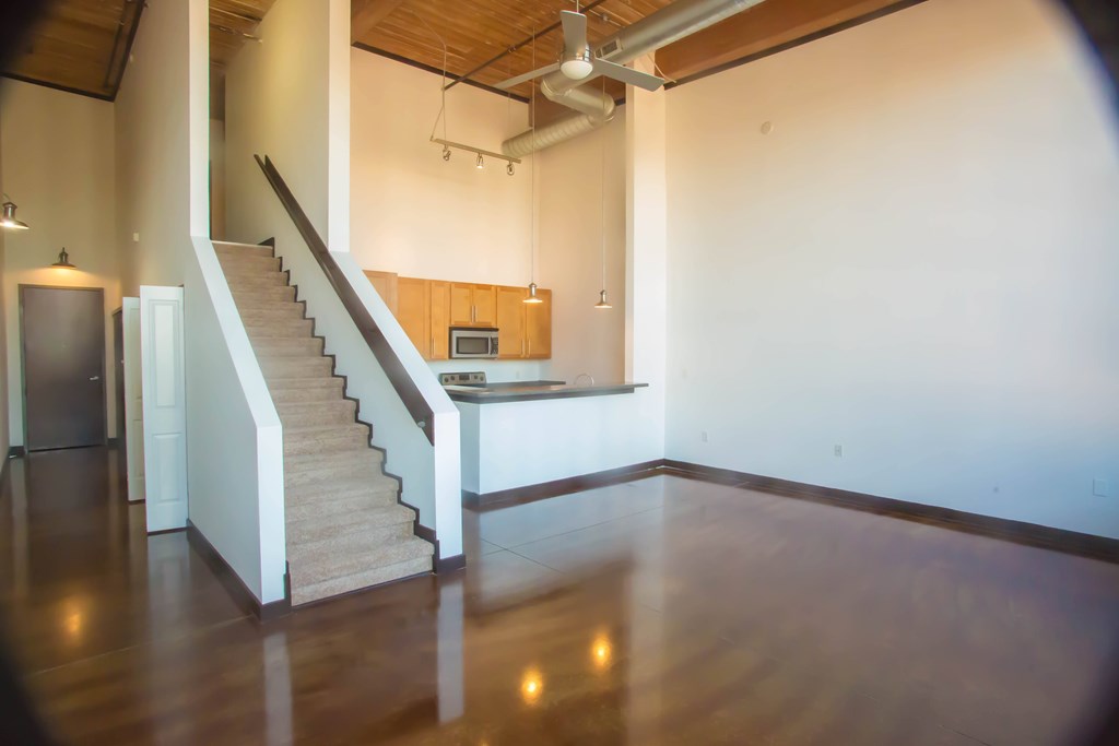 A kitchen with a staircase leading to the upper floor.