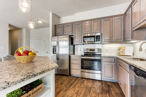 a kitchen with stainless steel appliances and granite counter tops