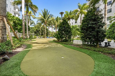 a golf course at a resort with palm trees