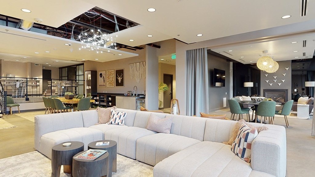 A modern living room with a large sectional sofa and a coffee table.