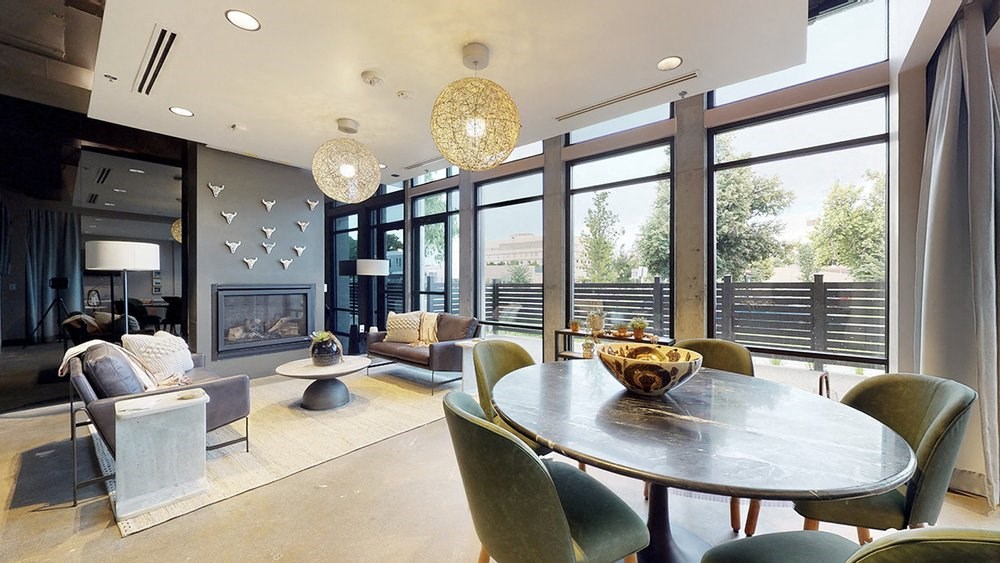 A modern dining room with a large table and chairs.