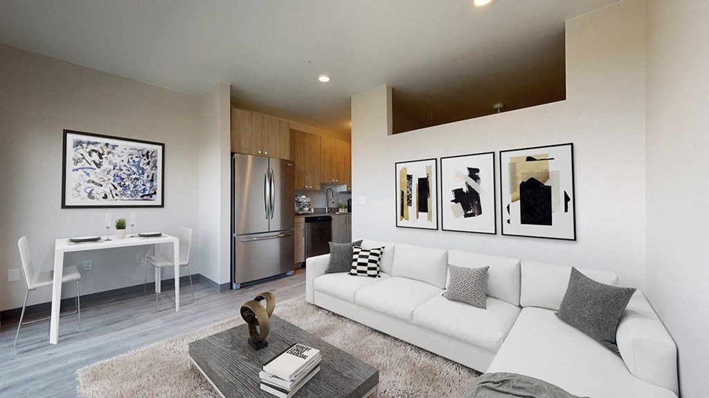 A modern living room with a white couch and a coffee table.