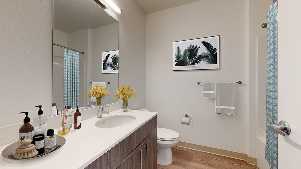 A bathroom with a white sink and a white toilet.
