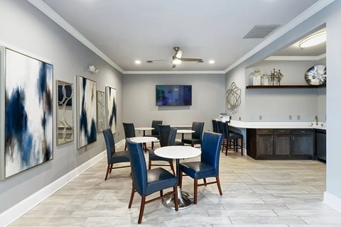 A dining room with a table set for four.