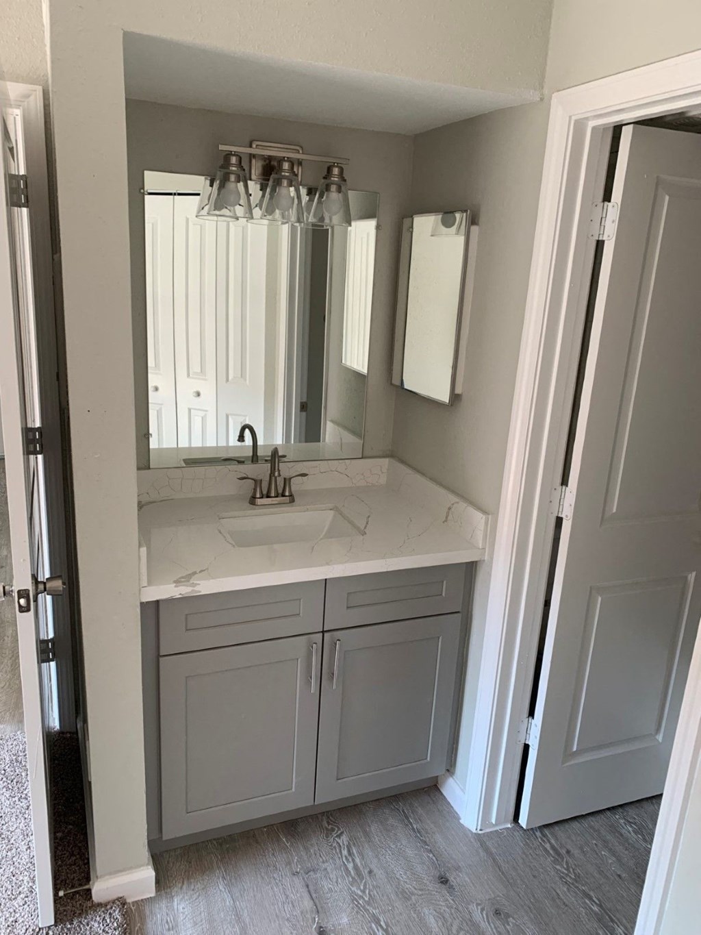 a white bathroom with a sink and a mirror