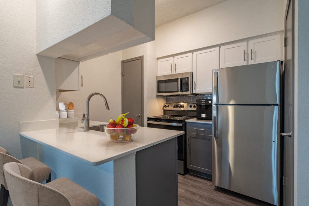 a kitchen with stainless steel appliances and a counter top