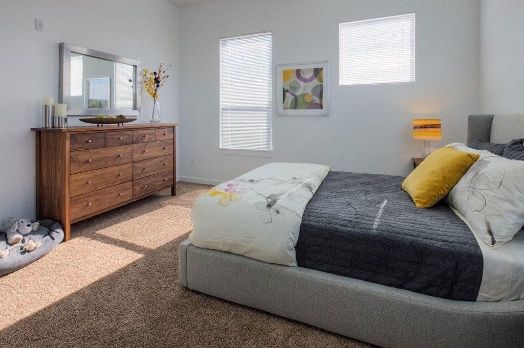 a bedroom with a bed and a dresser