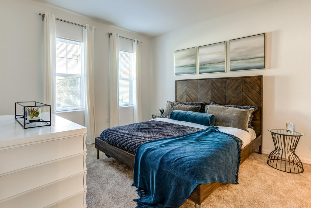 a bedroom with a bed and a large window