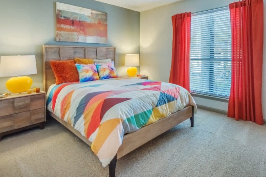 a bedroom with a bed and two night stands with lamps