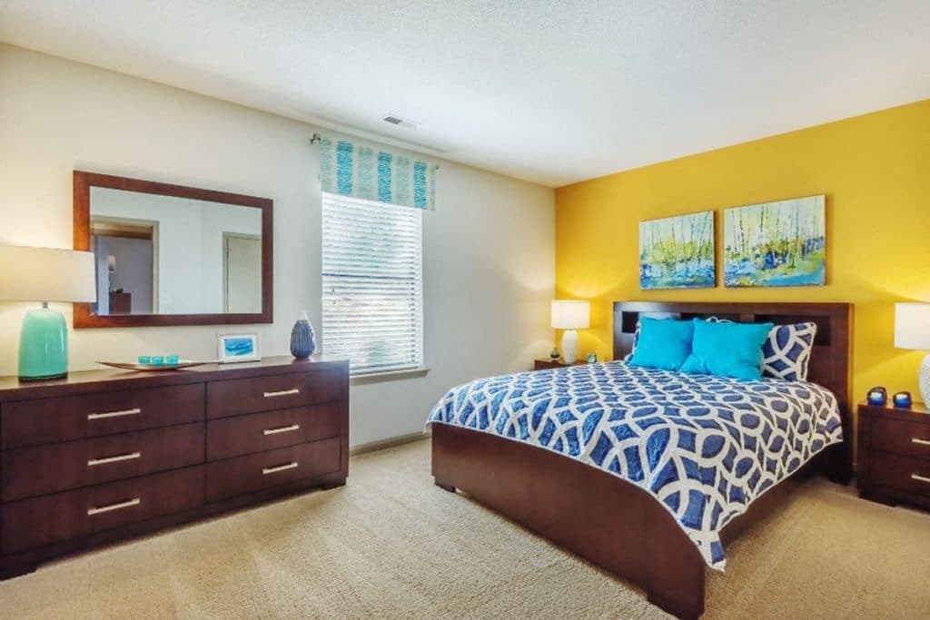 a bedroom with a bed and dresser