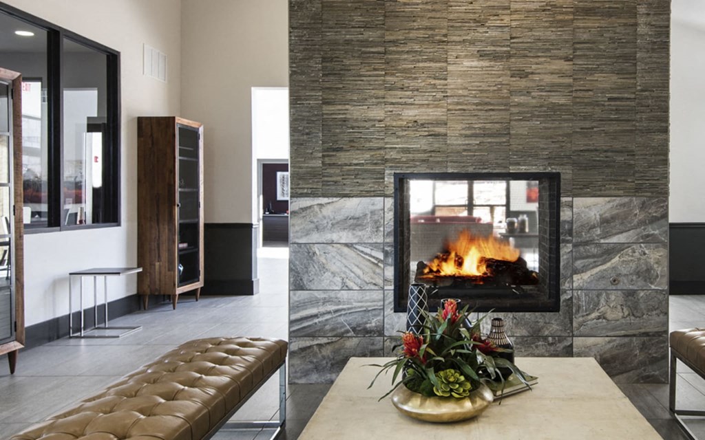 a living room with a fireplace and a table