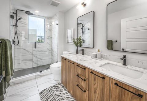 A bathroom with a white toilet, a sink, and a mirror.