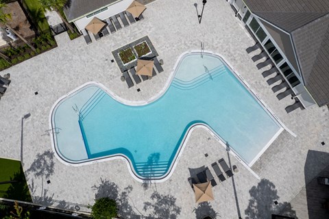 A large outdoor swimming pool surrounded by a patio area.