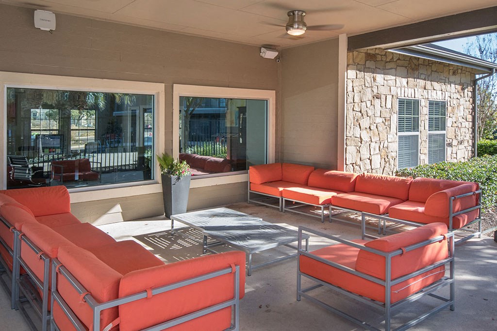Room with red sofas at The Palmera on 3009, Texas, 78154