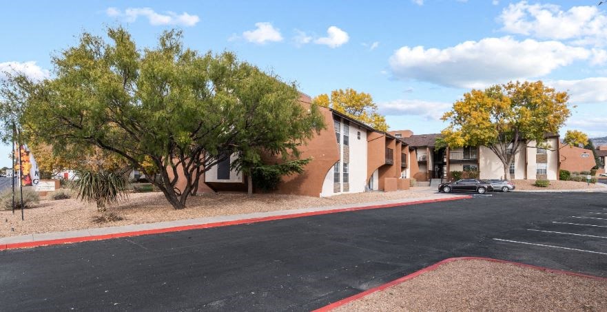 an empty street in front of an apartment building