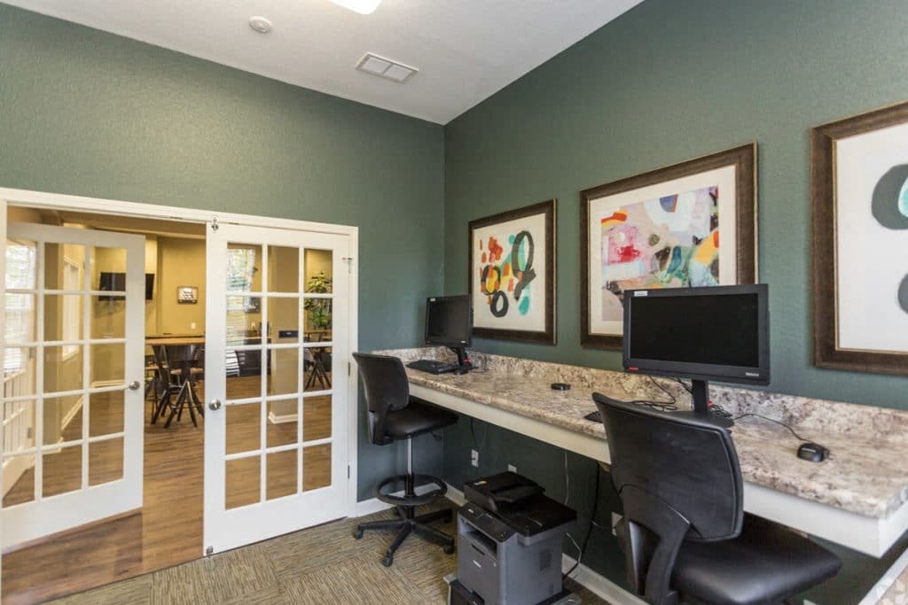 a home office with two computers and a counter top