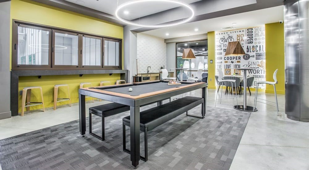 A modern dining room with a long table and chairs.