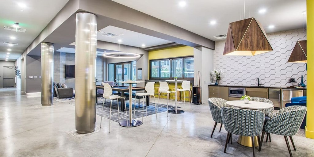 A modern dining area with a white table and chairs.