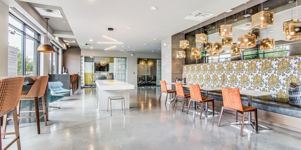 A modern dining area with a bar and chairs.
