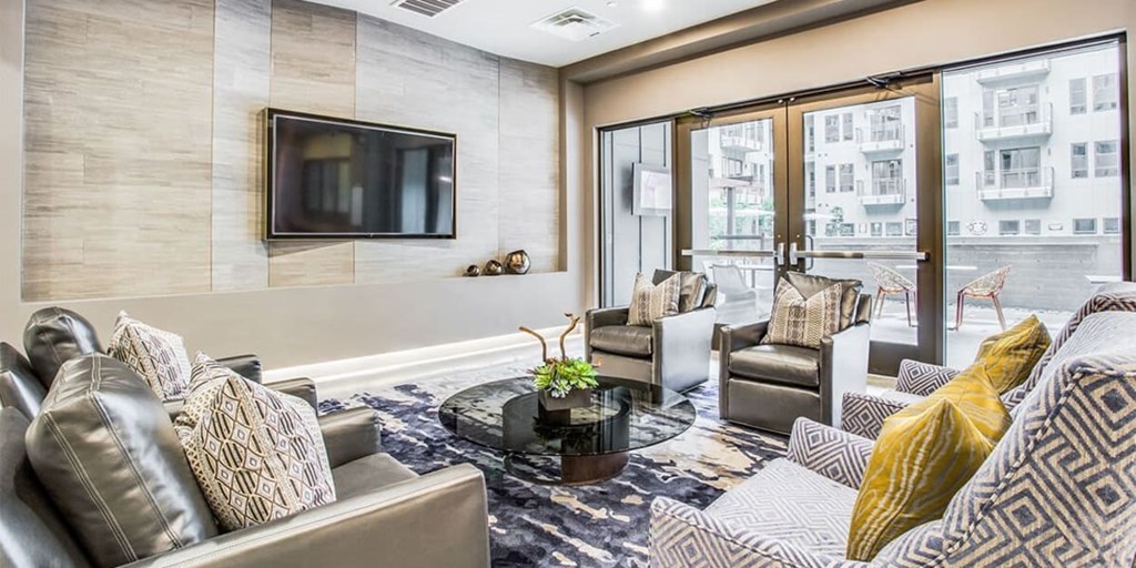 A living room with a grey couch and a coffee table.