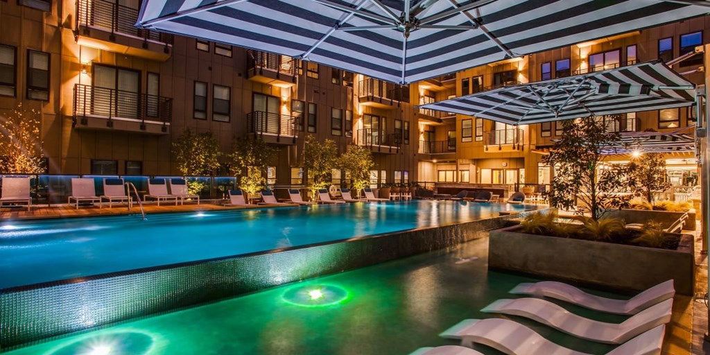 A swimming pool with a green light in the middle of it.