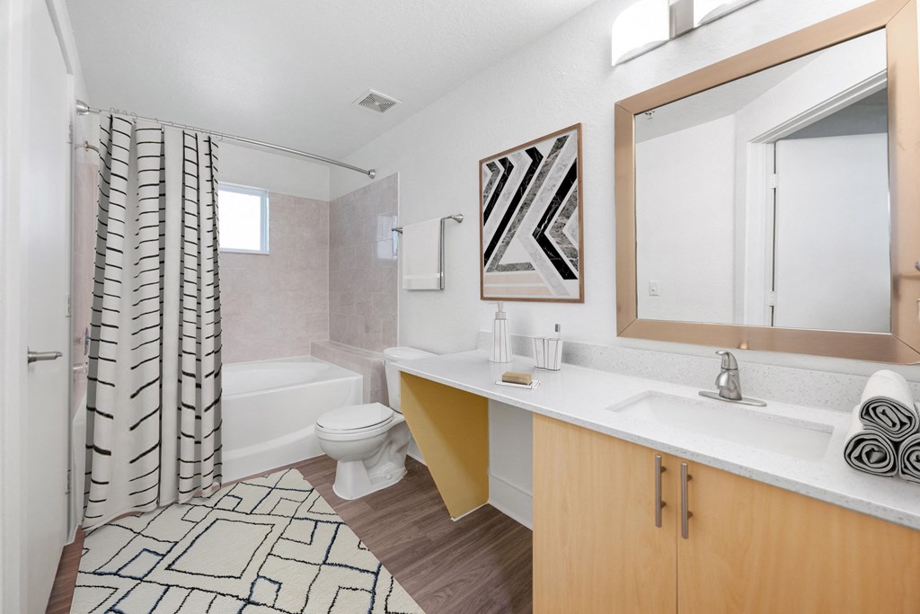 a bathroom with a tub and a sink and a toilet