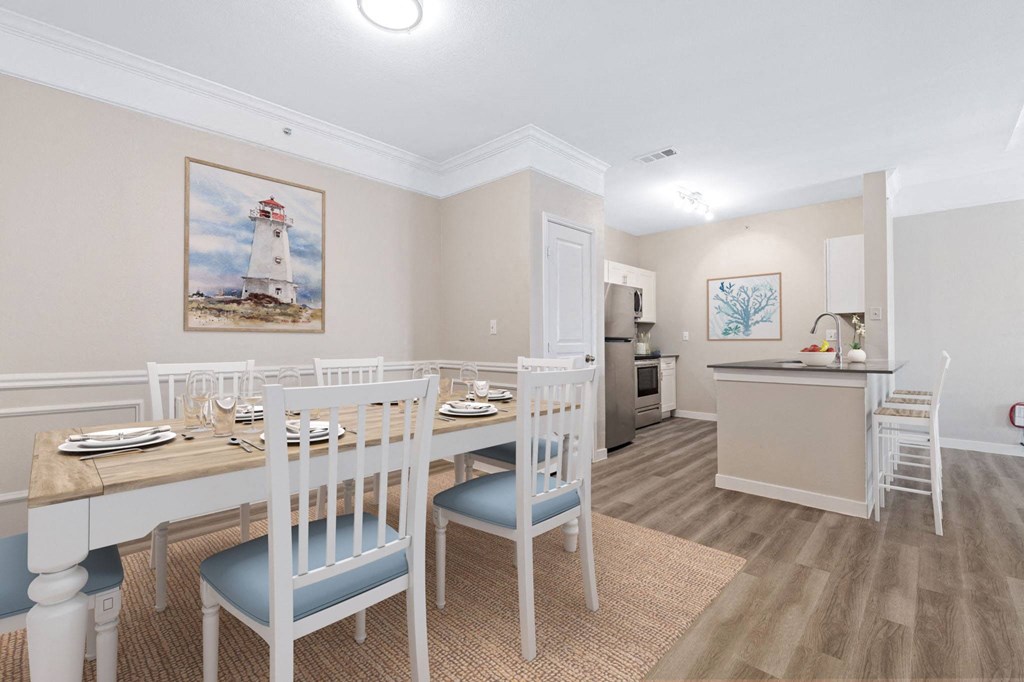 a dining room with a table and chairs