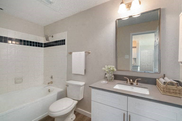 a bathroom with a sink toilet and a bath tub