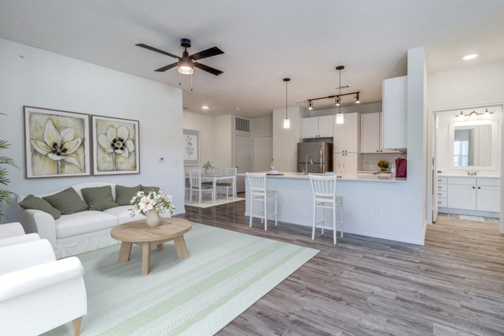 an open living room and kitchen with a ceiling fan