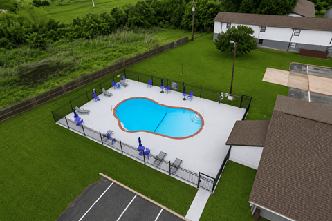 A small pool surrounded by a fence.