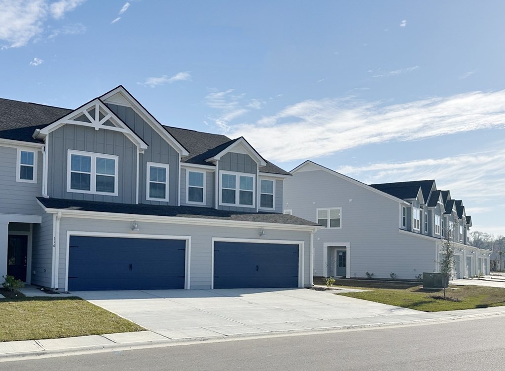 A row of houses with garages in front.