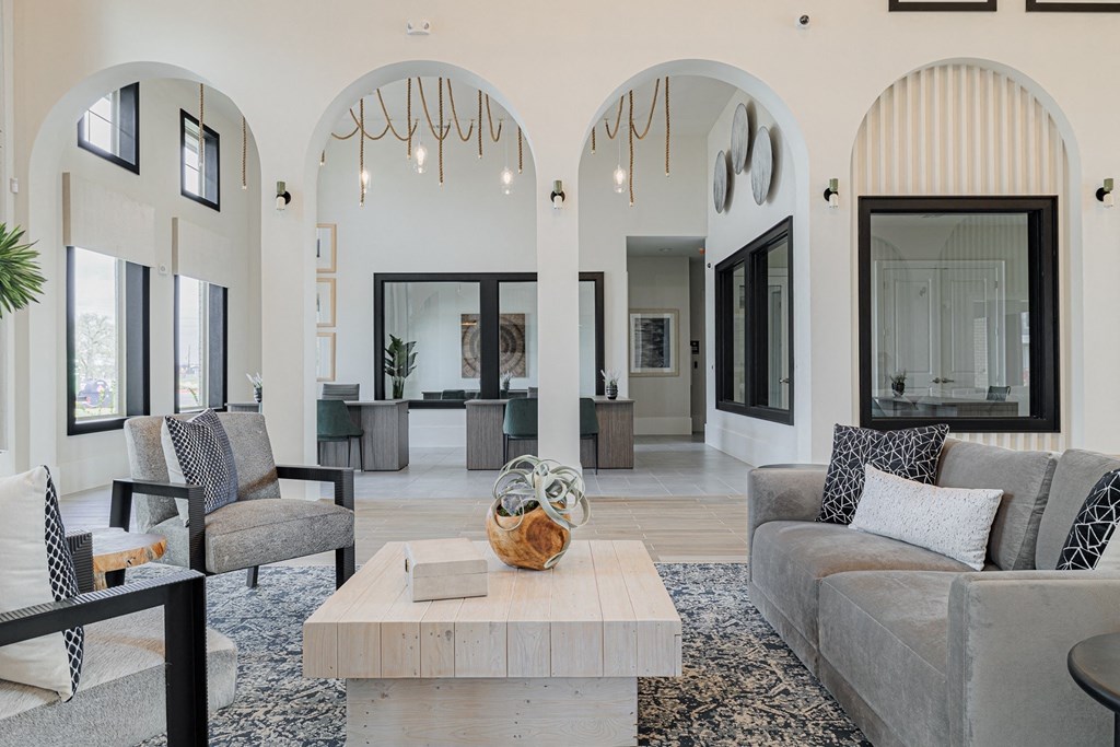 a living room with white walls and a large white coffee table in the middle of the room