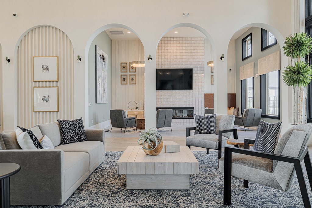 a living room filled with furniture and a large window