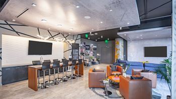 a large room with couches and chairs and a large screen on the wall