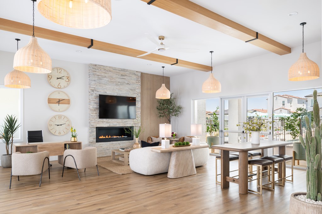 A modern living room with a fireplace and a large clock on the wall.