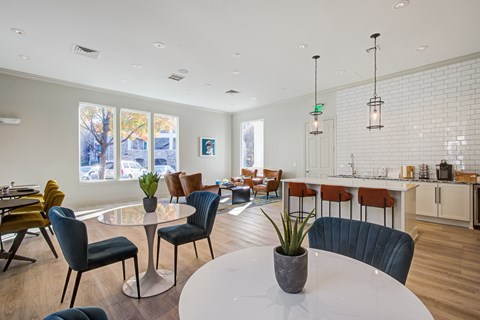 A modern dining room with a glass table and chairs.