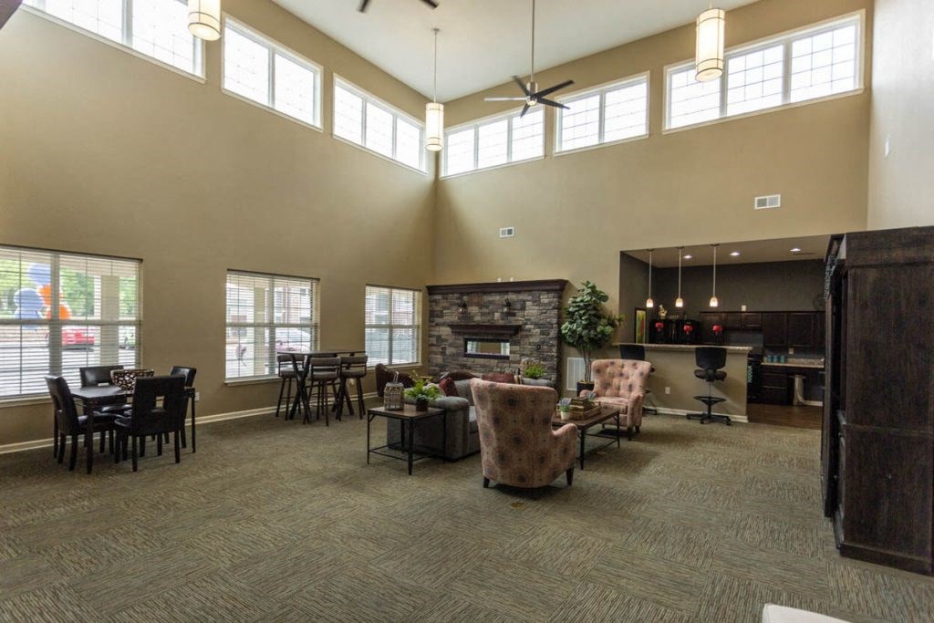 a large living room with furniture and a fireplace