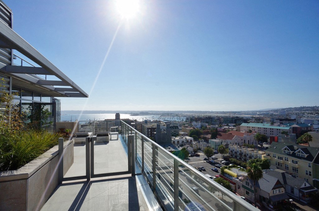 a balcony with a view of the city and the ocean