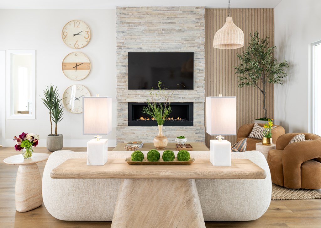A modern living room with a stone fireplace and a large clock on the wall.
