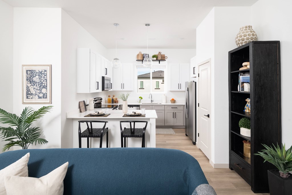A modern kitchen with a dining table and chairs.