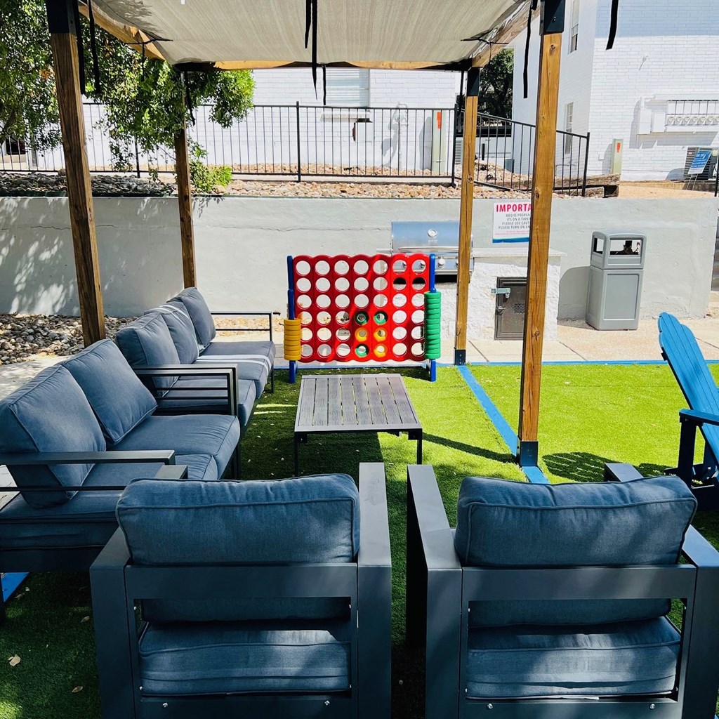 a seating area with chairs and a game of dominoes