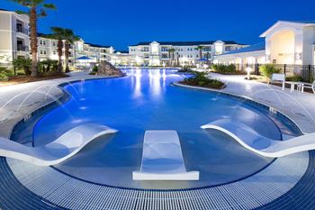 Resort-style swimming pool at night