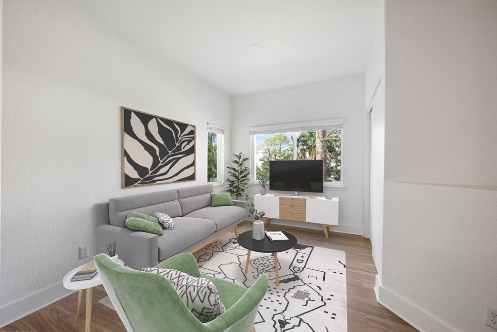 a living room with a gray couch and a tv