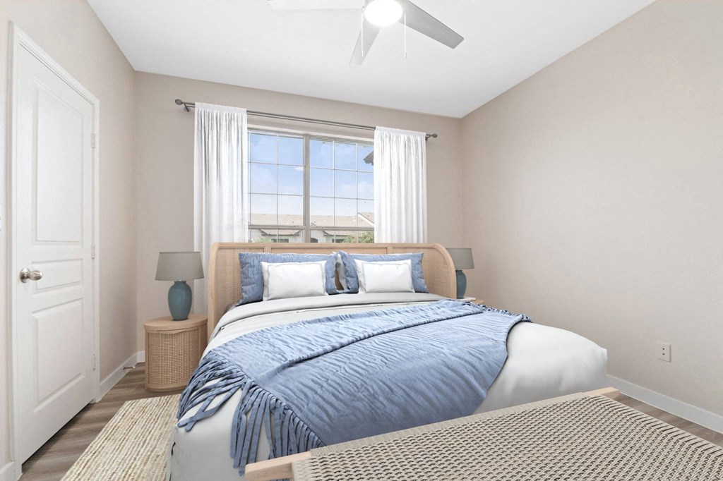 a bedroom with a bed and a ceiling fan