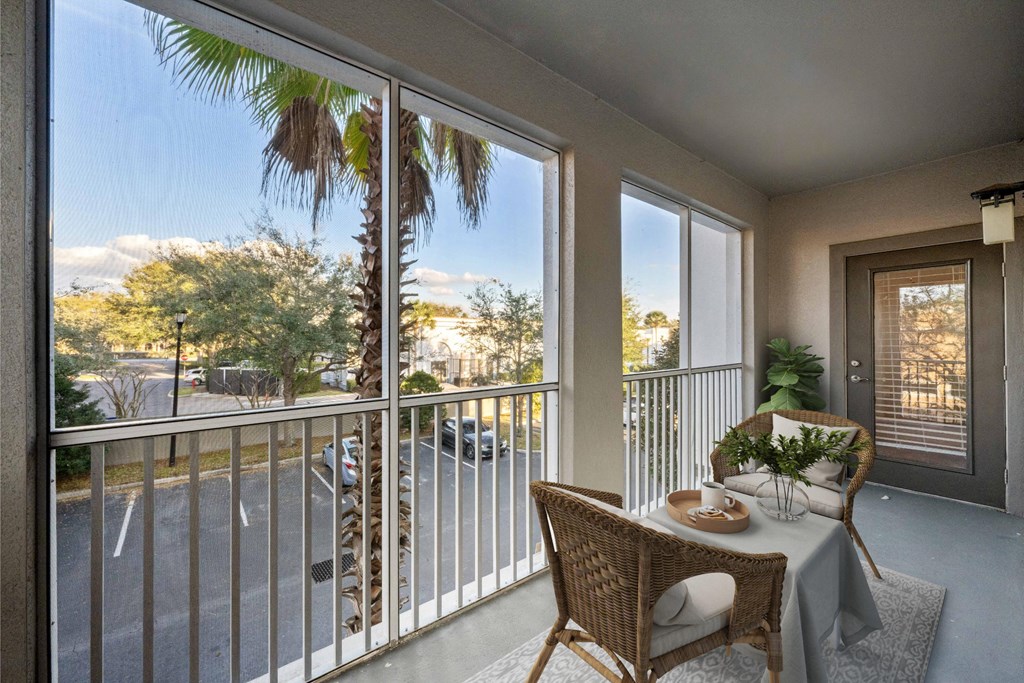 a dining room with a table and chairs on a balcony